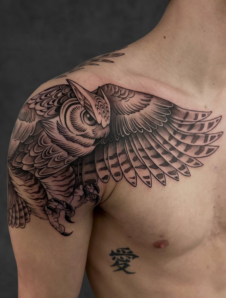 Black and grey lion face with wings tattoo