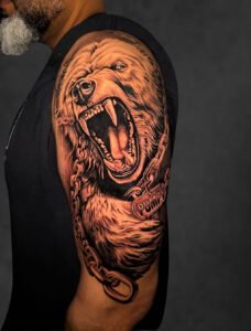 Black and grey roaring bear realism tattoo on upper arm — Undertone Tattoos Mohali